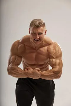 Handsome athletic man posing emotionally, high power Stock Photos