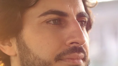 Handsome attractive arabic man with beard at sunset, close up view. Sun beams. Stock Footage 109457925