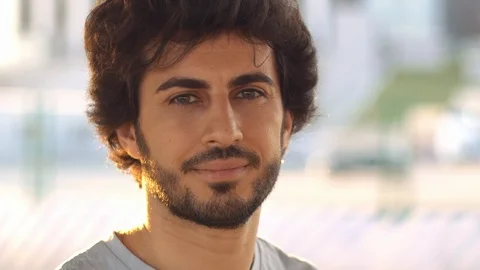 Handsome attractive arabic man with beard at sunset, close up view. Sun beams. Stock Footage 109458535