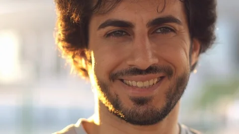 Handsome attractive eastern man with beard laughing on camera, atsunset, close Stock Footage 109457982