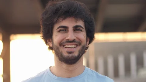 Handsome attractive eastern man with beard laughing on camera, atsunset, close Stock Footage 109458576