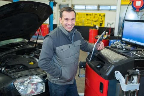 Handsome auto mechanic at work Stock Photos