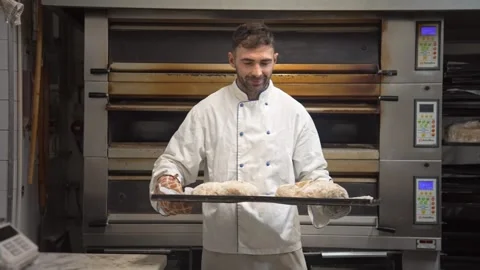 Handsome baker show done bread loafs bakery shop. Smiling man bake buns portrait Stock Footage 271222884