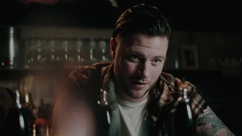 A handsome barman at the bar looking up and blinking Stock Footage 132012422