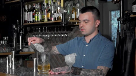 Handsome bartender preparing cocktail at the bar Stock Footage 137176545