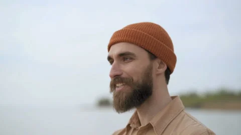 Handsome beard man enjoying nice day outdoors near the sea. Drinking tea. Stock Footage 106749485