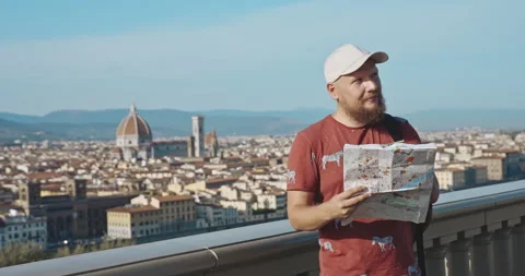 Handsome bearded guy exploring Italian city from viewpoint at sunset. Attractive Stock Footage 144245252