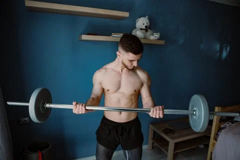 Handsome bearded guy working out at home Stock Photos