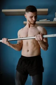 Handsome bearded guy working out at home Stock Photos