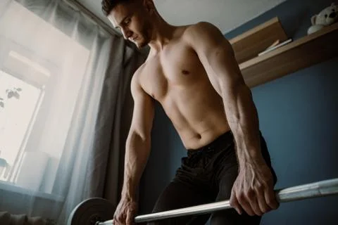 Handsome bearded guy working out at home Stock Photos