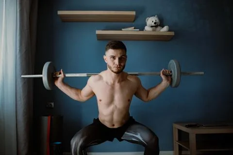 Handsome bearded guy working out at home Stock Photos