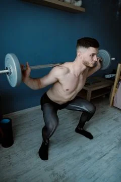 Handsome bearded guy working out at home Stock Photos