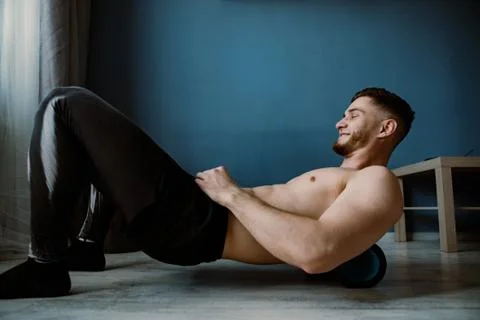 Handsome bearded guy working out at home Stock Photos