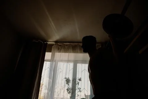 Handsome bearded guy working out at home Foto stock