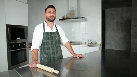 Handsome Bearded Man In Apron Posing In The Kitchen. He Looks So Happy. Stock Footage 95208528