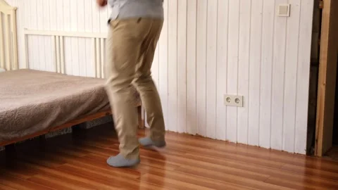 Handsome bearded man dance, have fun at home listens song, moves to music, feels Stock Footage 333472524