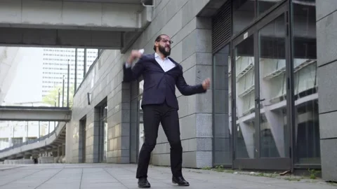 Handsome bearded man dancing outdoor, developing new application for smartphones Video stock 163352280