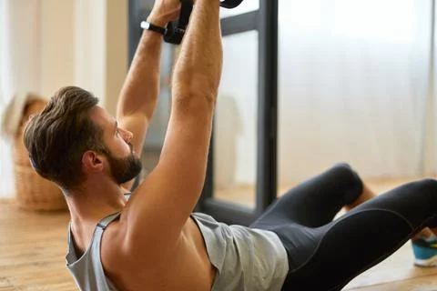 Handsome bearded man doing exercise with elastic fitness band Stock Photos