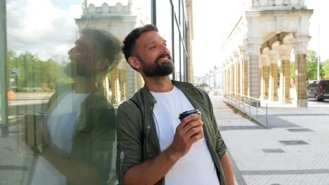 Handsome bearded man drinking coffee outdoors Stock Footage 344820279