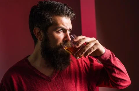 Handsome bearded man drinking whiskey. Strong alcohol. Degustation and tastin Stock Photos