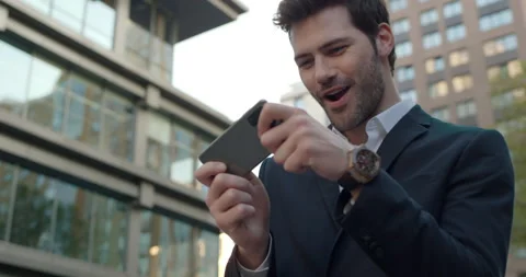 Handsome Bearded Man in Elegant suit playing Mobile Games using Smartphone Stock-Footage 155156352