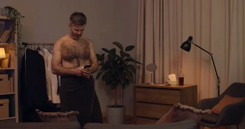 Handsome bearded man getting good news on his smartphone and rejoicing. Happy Stock Footage 135726387