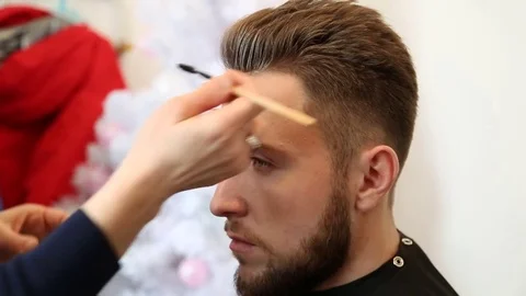 Handsome bearded man getting his hairstyle done. Stock Footage 74189941