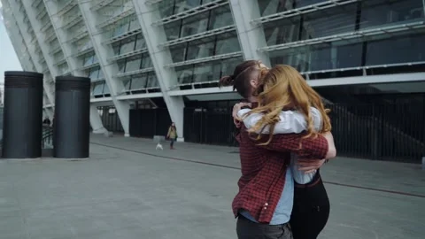 Handsome bearded man hugging his beautiful girl on the street Stock Footage 158794469