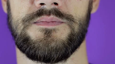 Handsome bearded man looking at the camera and showing his doubt. Close-up of a Stock Footage 135474455