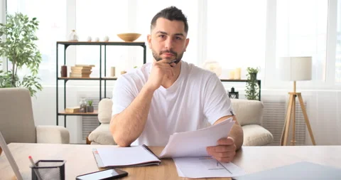 Handsome bearded man looking at camera, talking on video call 库存影片 150019083