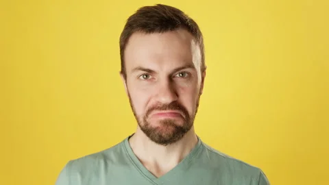 Handsome bearded man looking at camera and smiling at yellow background. Stock Footage 231299184
