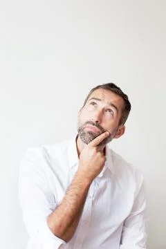 Handsome bearded man looking curious Stock Photos
