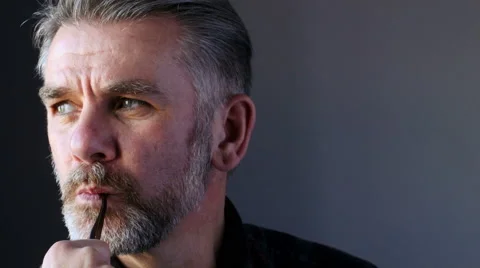 Handsome bearded man looks to camera Stock Footage 61756778