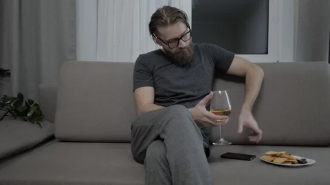 Handsome bearded man relaxing on sofa Video stock 104304741