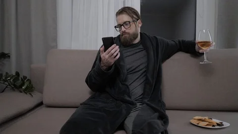 Handsome bearded man relaxing on sofa Stock Footage 104304778