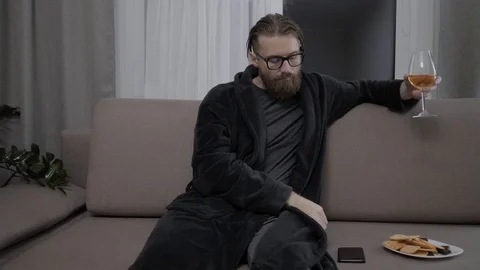 Handsome bearded man relaxing on sofa Stock Footage 104305058
