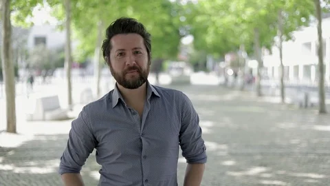 Handsome bearded man smiling at camera outdoor Stock-Footage 107993775