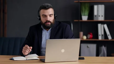Handsome bearded man teaching online talking to laptop web camera. Online Stock Footage 159357209