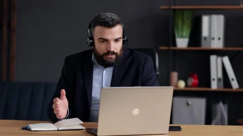 Handsome bearded man teaching online talking to laptop web camera. Online Stock Footage 162467708