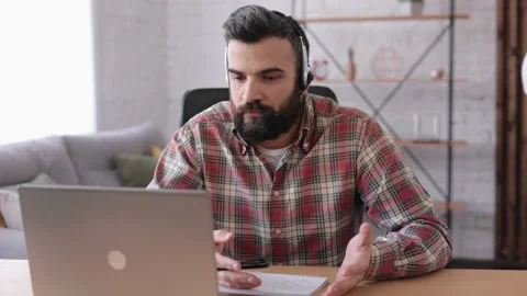 Handsome bearded man teaching online talking to laptop web camera. Online Stock Footage 164533536