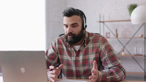 Handsome bearded man teaching online talking to laptop web camera. Online Stock Footage 166099458