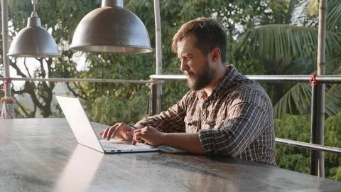 Handsome bearded man typing on laptop outdoor Stock Footage 101275372