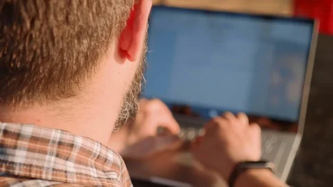 Handsome bearded man typing on laptop outdoor Stock Footage 101372643
