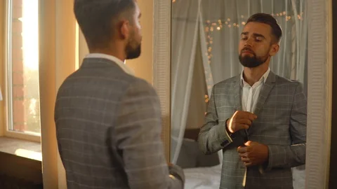 Handsome bearded man is using atomizer nozzle with perfume Stock-Footage 116335101