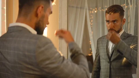 Handsome bearded man is using atomizer nozzle with perfume Stock-Footage 116335265