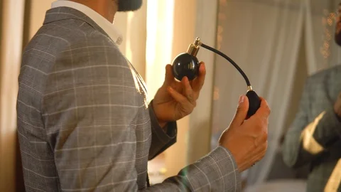 Handsome bearded man is using atomizer nozzle with perfume Stock-Footage 116335428