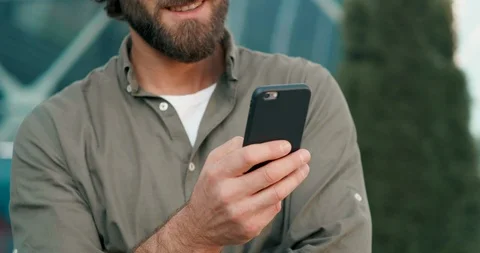 Handsome Bearded Man Using Social networks on his Smartphone, looking at Screen Stock Footage 125146127
