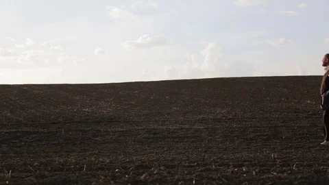 A handsome bearded man is walking in the field. Stock Footage 75379971