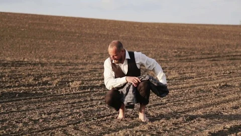A handsome bearded man is walking in the field. Stock Footage 75381682