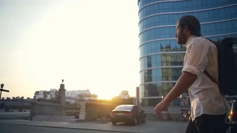 Handsome bearded man walking with his bicycle down the street slow motion Video stock 79237425